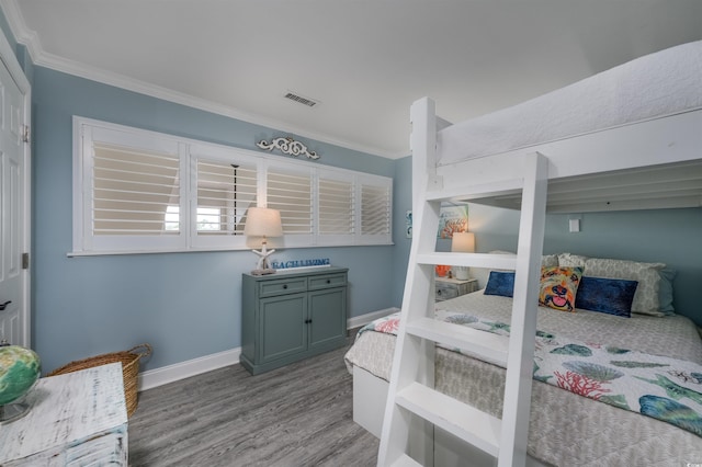 bedroom featuring crown molding and light wood-type flooring