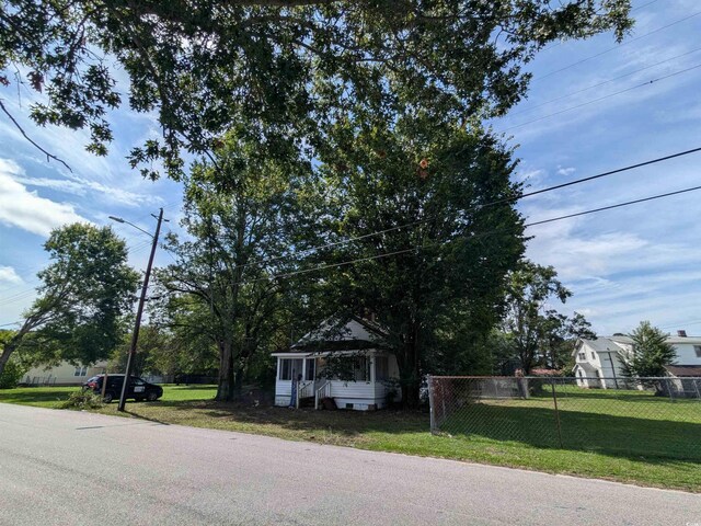 view of front of property featuring a front lawn and a sunroom