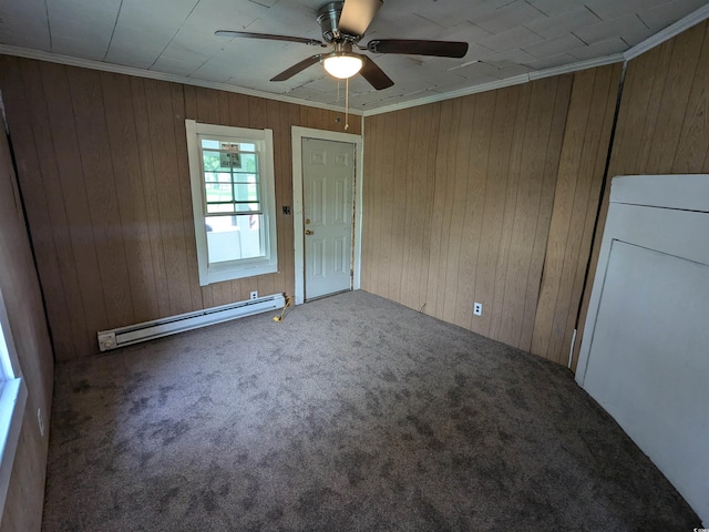 unfurnished room with a ceiling fan, crown molding, a baseboard heating unit, and carpet flooring