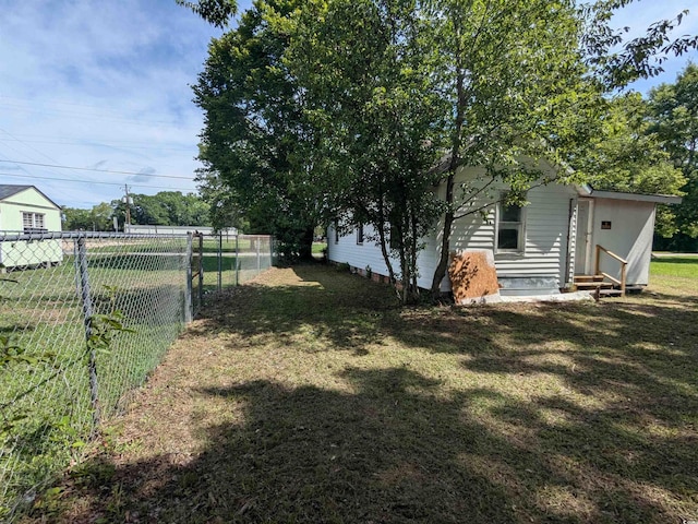 view of yard featuring entry steps and fence