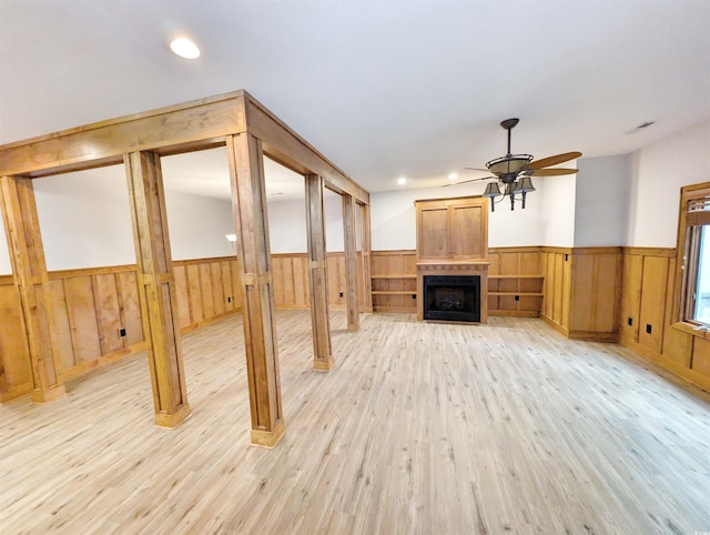 unfurnished living room with ceiling fan and light hardwood / wood-style floors