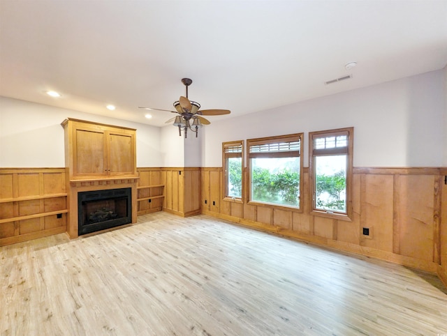 unfurnished living room featuring light hardwood / wood-style floors and ceiling fan