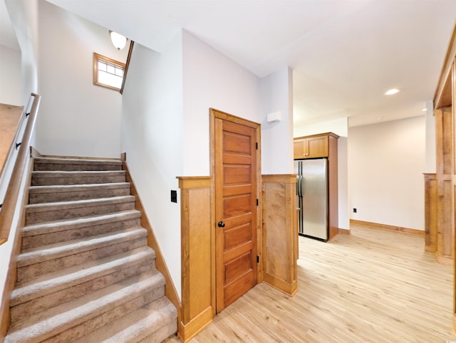 stairway with hardwood / wood-style floors