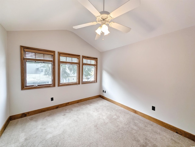 carpeted empty room featuring ceiling fan and lofted ceiling