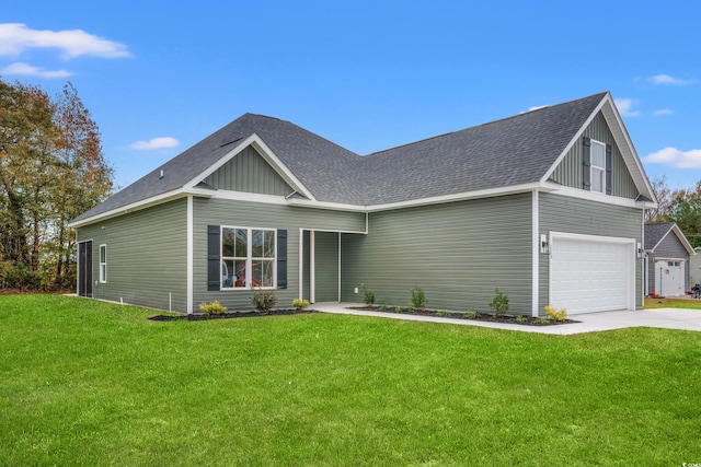 view of front of home with an attached garage, concrete driveway, a front lawn, and a shingled roof