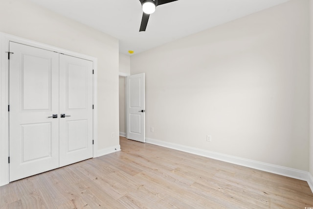 unfurnished bedroom with light wood-style floors, a ceiling fan, baseboards, and a closet