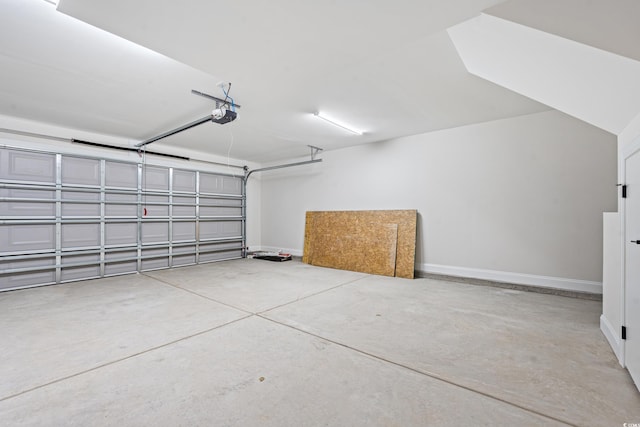 garage with baseboards and a garage door opener