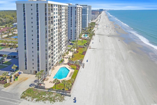 bird's eye view with a water view and a beach view