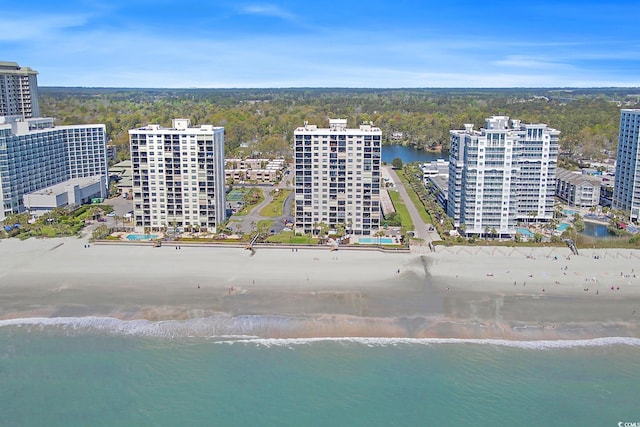 birds eye view of property with a view of the beach and a water view