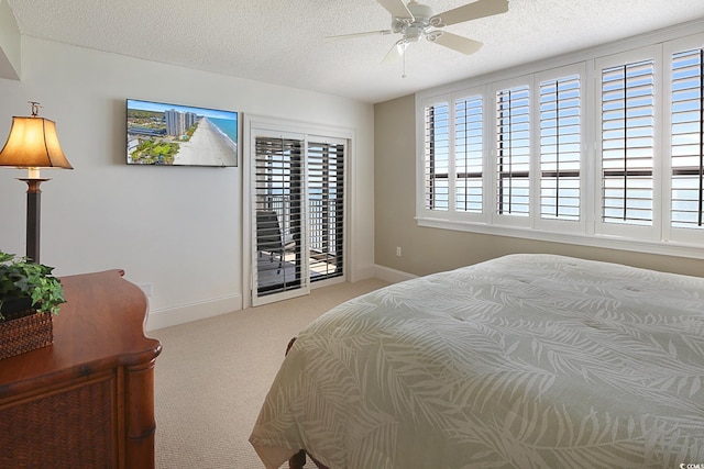 carpeted bedroom with access to outside, multiple windows, ceiling fan, and a textured ceiling