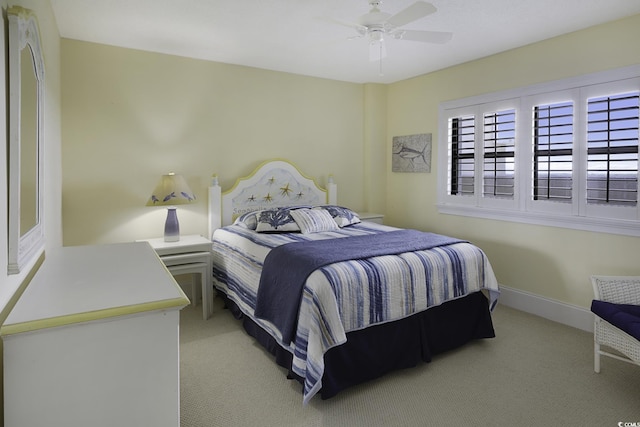 bedroom featuring ceiling fan and light carpet