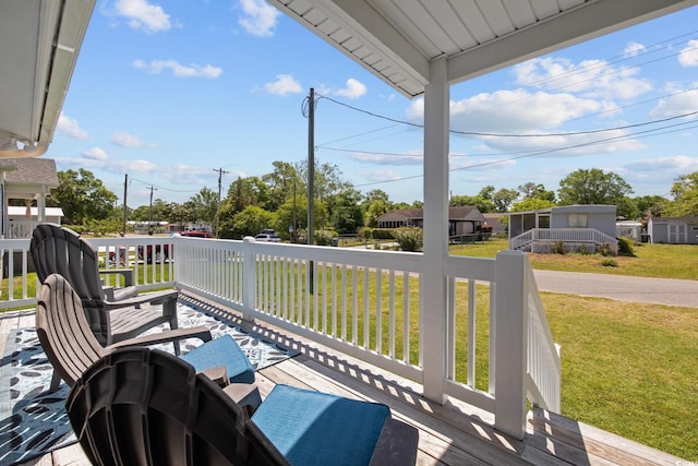 wooden terrace with a yard