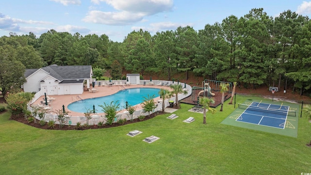 view of pool with an outbuilding, a playground, and a lawn