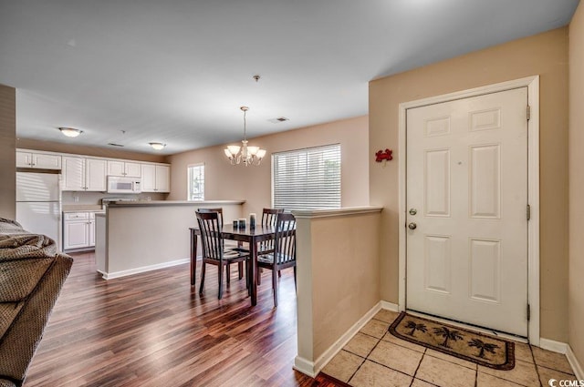 entrance foyer with a chandelier and hardwood / wood-style flooring