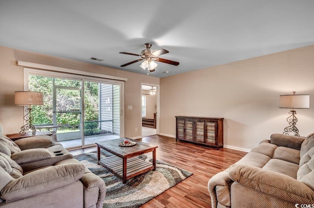 living room featuring ceiling fan and hardwood / wood-style floors