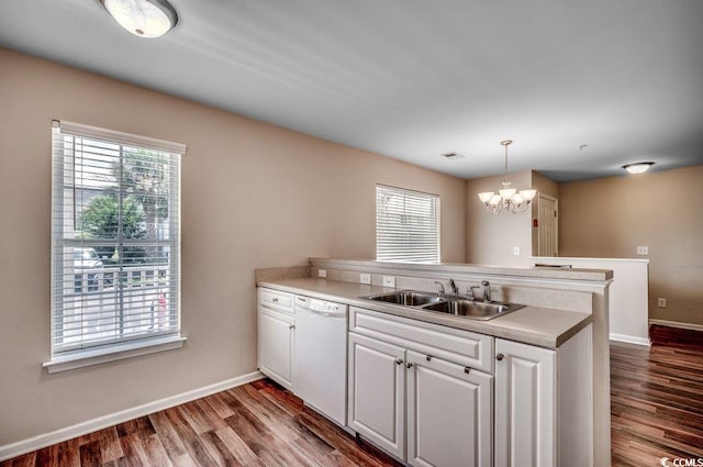 kitchen with an inviting chandelier, decorative light fixtures, white dishwasher, and wood-type flooring