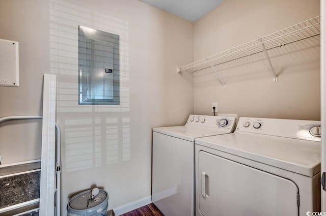 clothes washing area with separate washer and dryer and electric panel