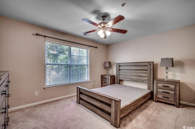 bedroom with light carpet and ceiling fan