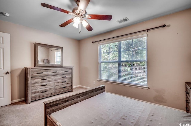 bedroom featuring light colored carpet and ceiling fan