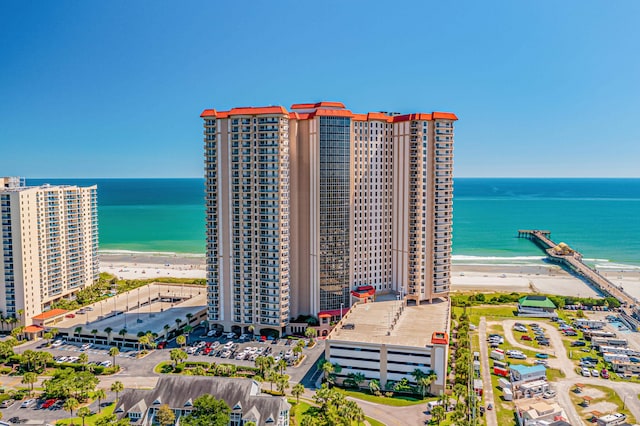 birds eye view of property with a beach view and a water view