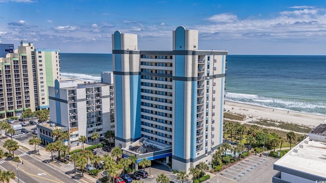 exterior space featuring a water view and a beach view