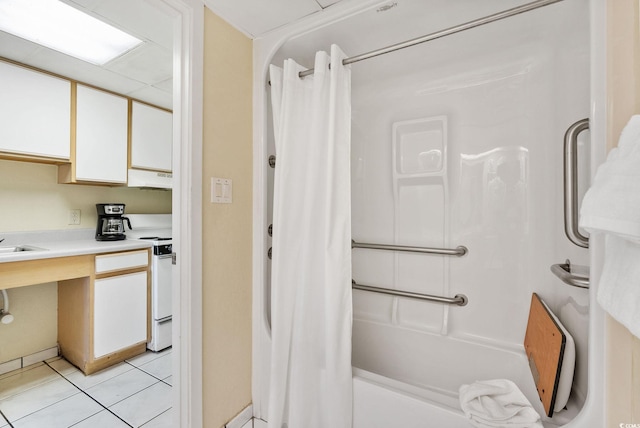 bathroom featuring tile patterned flooring, shower / bath combo with shower curtain, and vanity