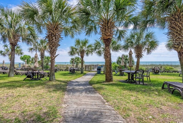 view of community with a yard and a water view