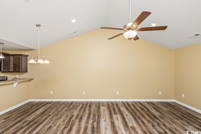 unfurnished living room featuring ceiling fan with notable chandelier, vaulted ceiling, and hardwood / wood-style flooring