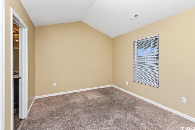 unfurnished bedroom featuring carpet and lofted ceiling