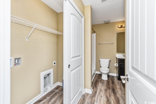 laundry room featuring hookup for an electric dryer and hardwood / wood-style flooring