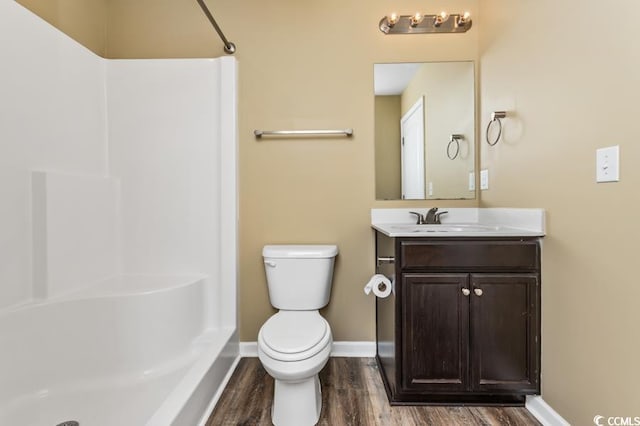 bathroom featuring vanity, hardwood / wood-style floors, and toilet