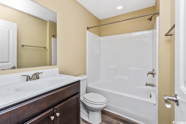 full bathroom featuring shower / bathing tub combination, wood-type flooring, toilet, and vanity