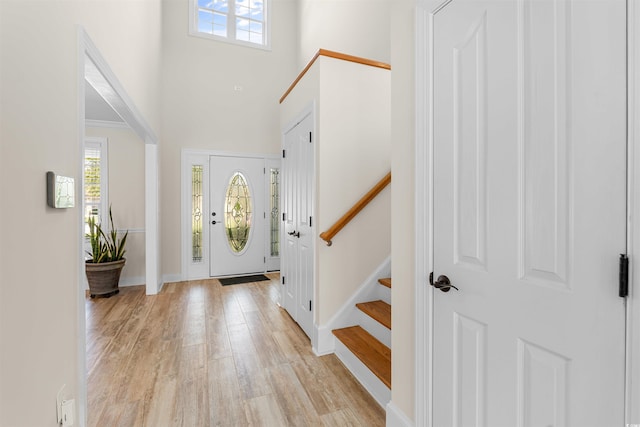 foyer featuring a high ceiling and light hardwood / wood-style floors