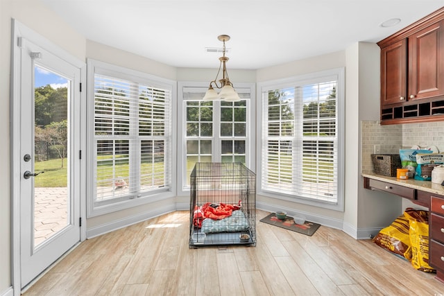 sunroom / solarium featuring a healthy amount of sunlight