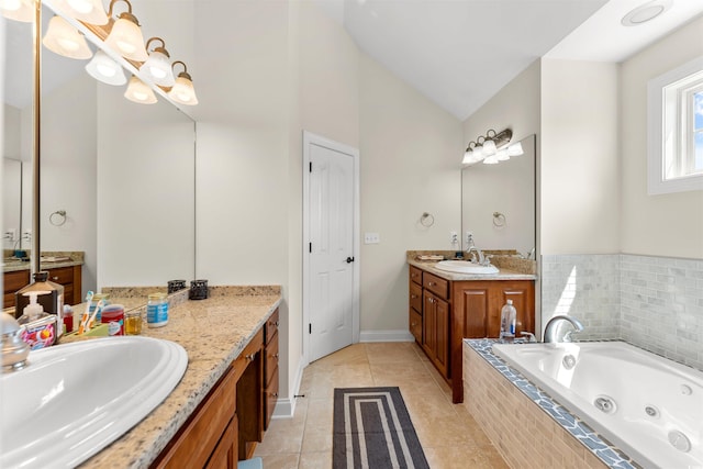 bathroom featuring tile patterned flooring, vanity, tiled bath, and vaulted ceiling