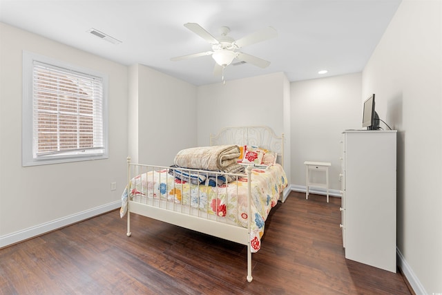 bedroom with dark hardwood / wood-style floors and ceiling fan