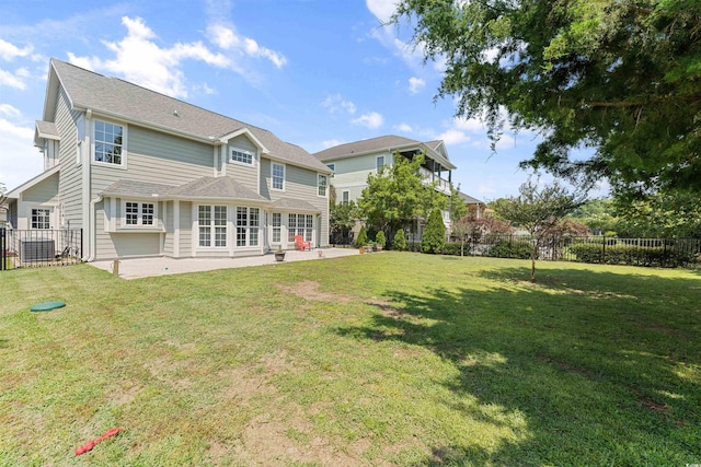 rear view of house with a patio area and a yard