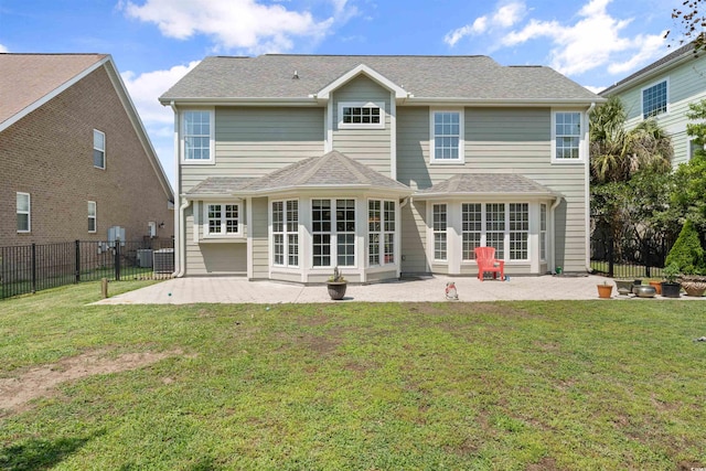 back of property featuring a lawn, central air condition unit, and a patio