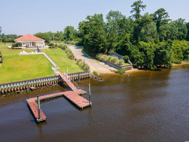 dock area with a water view and a lawn