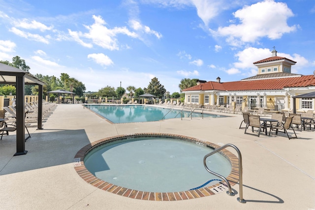 view of swimming pool with a gazebo and a patio area