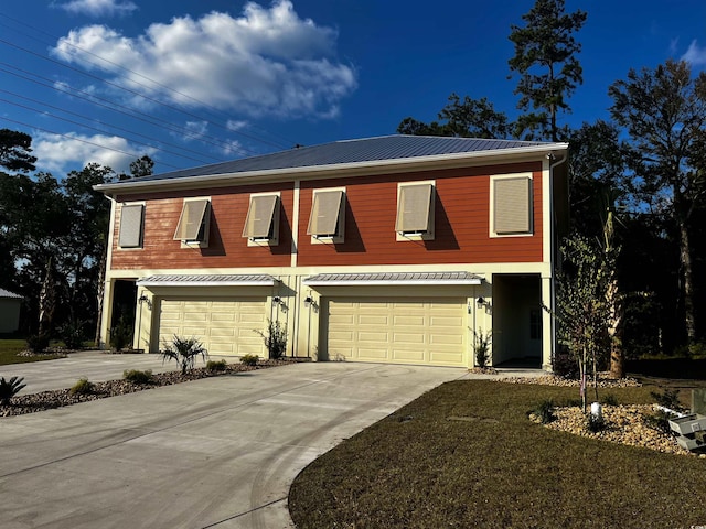 108 Hallandale Ln, Murrells Inlet, SC 29576 - view of front of home with an attached garage, concrete driveway, and metal roof