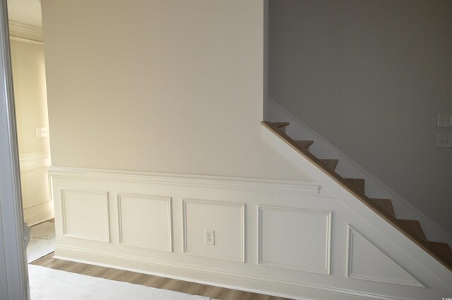 108 Hallandale Ln, Murrells Inlet, SC 29576 - stairway with a decorative wall, wainscoting, and wood finished floors