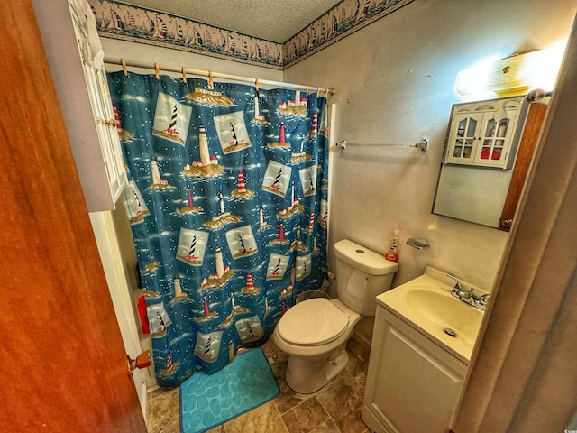 bathroom featuring curtained shower, toilet, a textured ceiling, and vanity