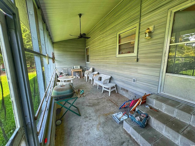 unfurnished sunroom featuring vaulted ceiling and ceiling fan