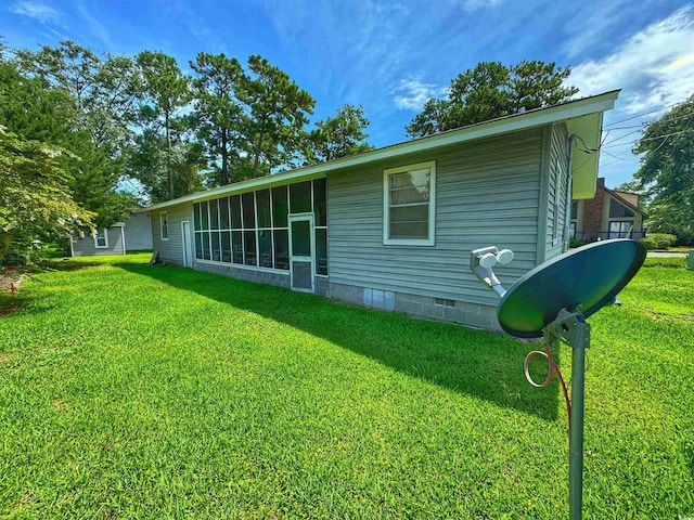 back of house featuring crawl space and a lawn