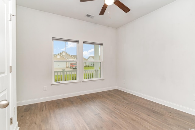 empty room featuring wood-type flooring and ceiling fan