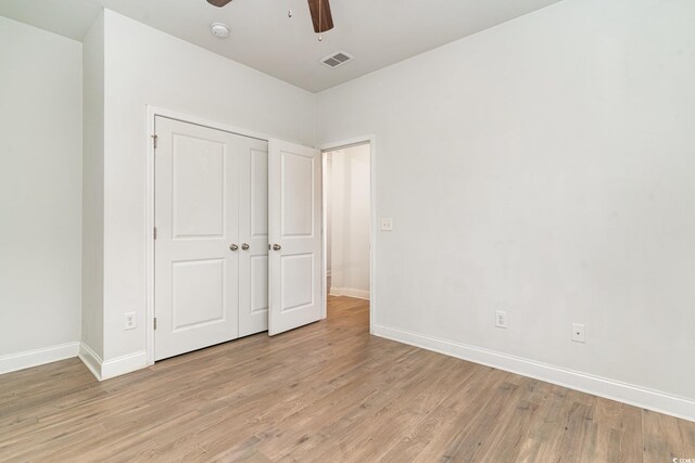 unfurnished bedroom featuring light hardwood / wood-style floors and ceiling fan