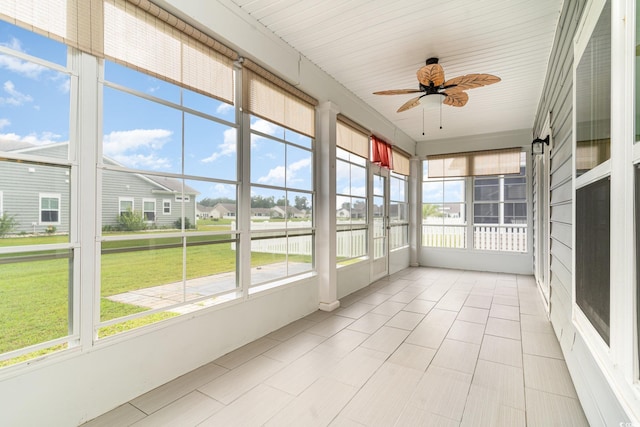 unfurnished sunroom with ceiling fan and a wealth of natural light