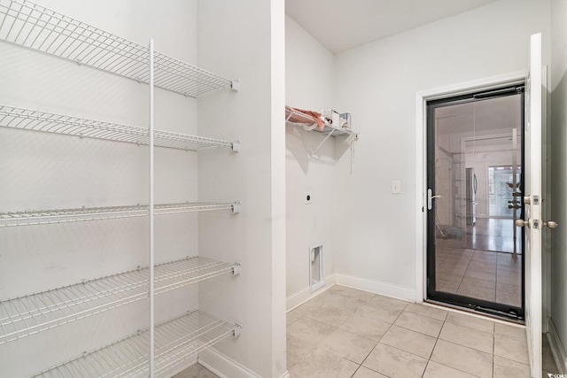 walk in closet with light tile patterned floors