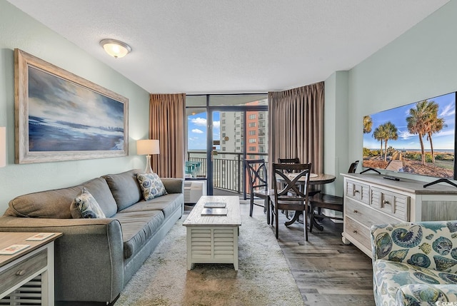 1501 S Ocean Blvd Unit 1150, Myrtle Beach, SC 29577 - living room featuring a wall of windows, wood finished floors, and a textured ceiling